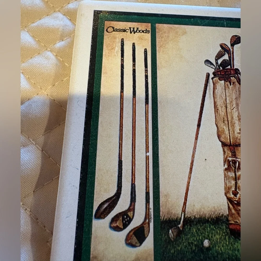 Vintage ceramic coasters depicting classic golf clubs.